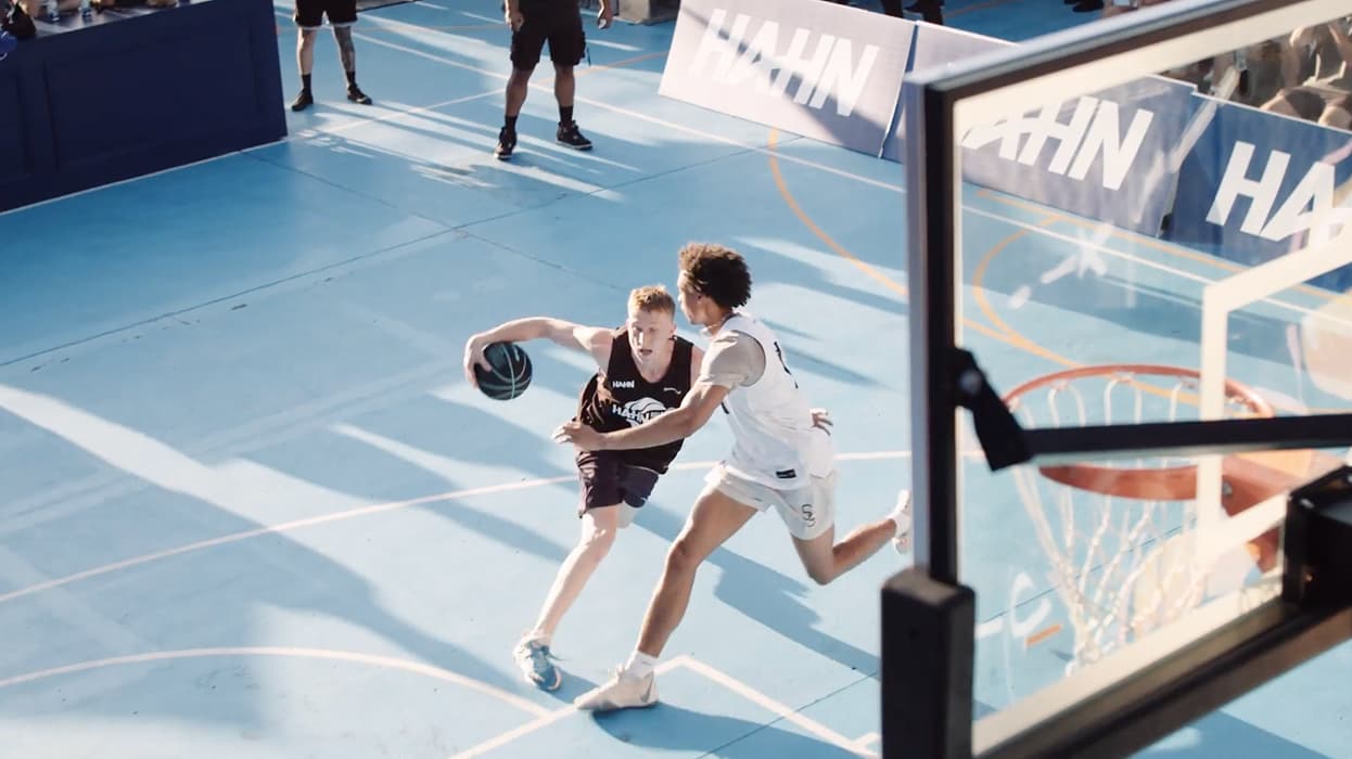 2 young men playing basketball